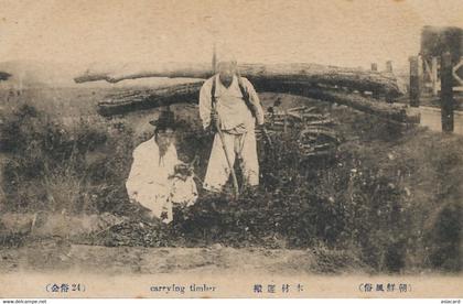 Carrying timber  . Man carrying big load of wood. Homem transportant grumes bois sur son dos .  Korean type .