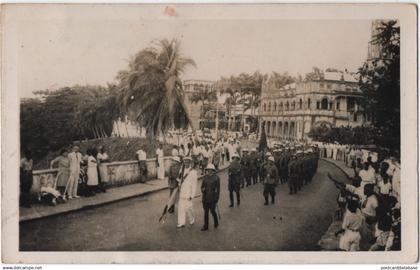 Untitled card written from Santa Isabel - & parade,soldiers,palm trees,colonial buildings,crowd