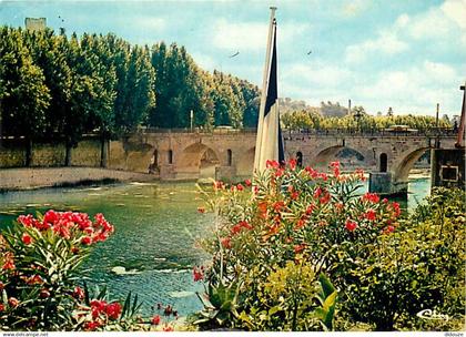 30 - Sommières - Le pont romain sur le Vidourle, la tour (Xe s) - Fleurs - Flamme Postale de Sommières - CPM - Voir Scan