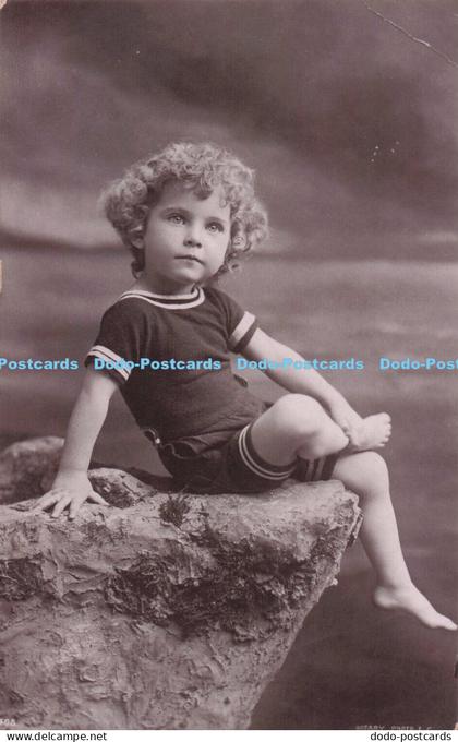 R697574 Little Child Sitting on a Rock. Rotary Photo. 1906