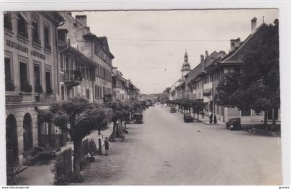 Bulle, Grand'rue.  Café Gruyérien, librairie Baudère. Carte-photo